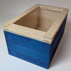Das Werkstück das in diesem Kurs angefertigt ist, eine Holzkiste mit Glasfüllung und blauer Farbe an den Seiten.